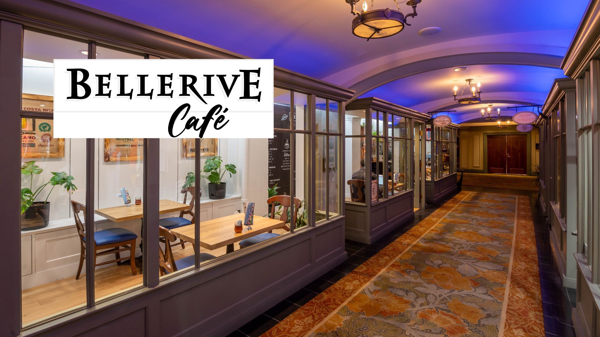 Hotel corridor overlooking the windowed exterior of Le Bellerive Café.